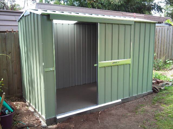 Gable roof shed with sliding door and skylight on a rebated concrete floor